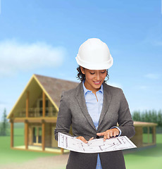 Image showing businesswoman in white helmet with blueprint