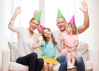 Image showing happy family with two kids in hats celebrating