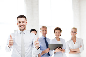 Image showing businessman in office showign thumbs up