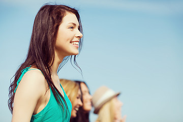 Image showing girl with friends walking on the beach