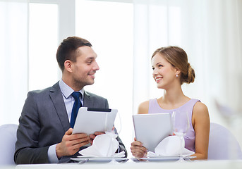 Image showing couple with menus on tablet pc at restaurant