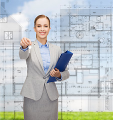 Image showing smiling businesswoman with folder and keys