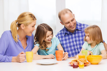 Image showing happy family with two kids with having breakfast