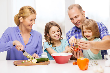 Image showing happy family with two kids making dinner at home