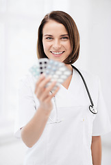 Image showing doctor with blister packs of pills