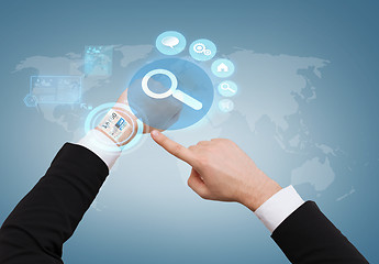 Image showing businessman pointing to virtual watch at his hand