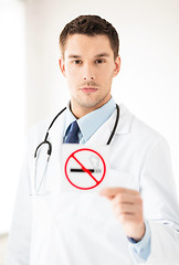 Image showing male doctor holding no smoking sign
