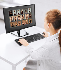 Image showing editor choosing pictures from computer monitor