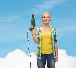 Image showing smiling woman with drill machine