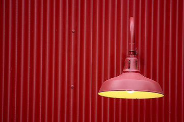 Image showing Red light against red metal background