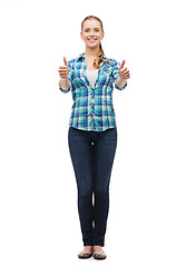 Image showing young woman in casual clothes showing thumbs up