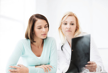 Image showing doctor with patient looking at x-ray