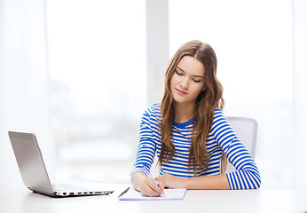 Image showing teenage girl laptop computer and notebook