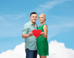 Image showing smiling couple holding big red heart