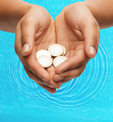 Image showing womans cupped hands showing euro coins