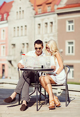 Image showing couple with map in cafe