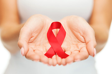 Image showing hands holding red AIDS awareness ribbon