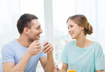 Image showing smiling couple having breakfast at home