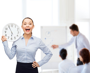 Image showing attractive businesswoman with wall clock