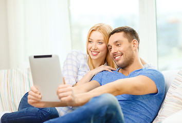 Image showing smiling happy couple with tablet pc at home