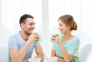 Image showing smiling couple having breakfast at home