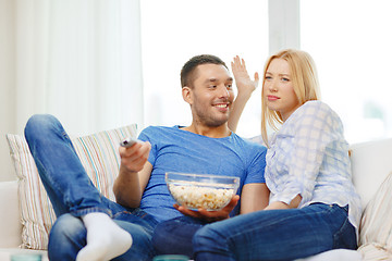 Image showing smiling couple with popcorn choosing what to watch