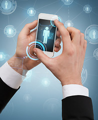 Image showing businessman touching screen of smartphone