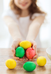 Image showing close up of girl holding colored eggs