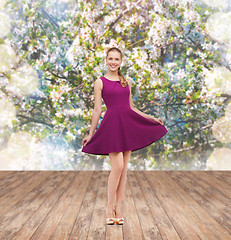 Image showing young woman in purple dress and high heels