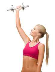 Image showing smiling woman with heavy steel dumbbell