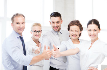 Image showing business team showing thumbs up in office