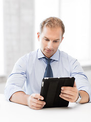 Image showing businessman with tablet pc in office