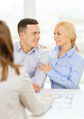 Image showing smiling couple looking at blueprint