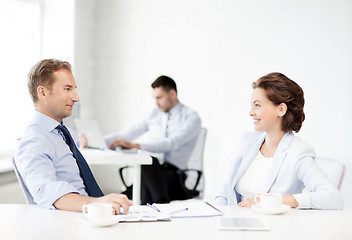 Image showing man and woman discussing something in office
