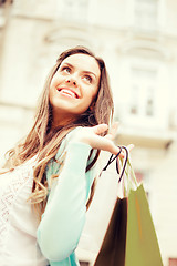 Image showing woman with shopping bags in city