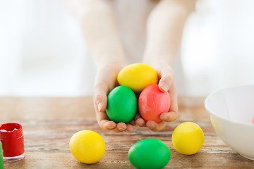 Image showing close up of girl holding colored eggs