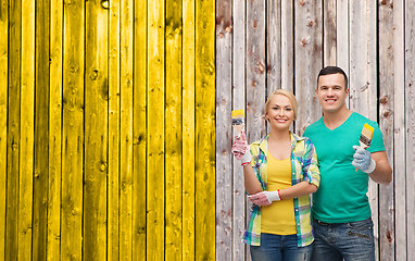 Image showing smiling couple with paintbrush