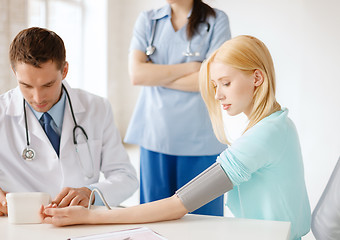 Image showing male doctor, female nurse and patient in hospital