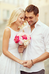 Image showing couple with flowers in the city