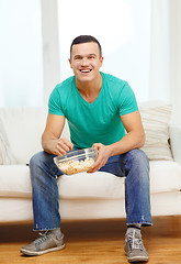 Image showing smiling man watching sports at home