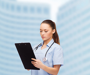 Image showing serious female doctor or nurse with stethoscope