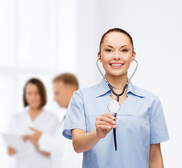 Image showing smiling female doctor or nurse with stethoscope