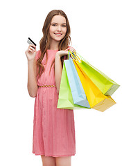 Image showing smiling woman in dress with many shopping bags