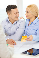 Image showing couple looking at blueprint and color samples