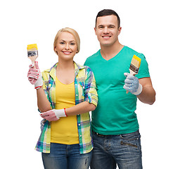 Image showing smiling couple with paintbrush