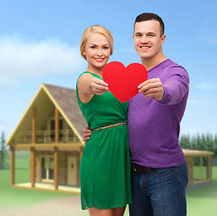 Image showing smiling couple holding big red heart