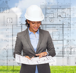 Image showing businesswoman in white helmet with blueprint