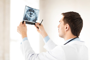 Image showing male doctor or dentist looking at x-ray