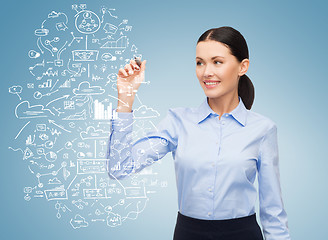 Image showing businesswoman writing plan in the air