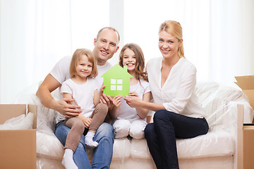 Image showing smiling parents and two little girls at new home